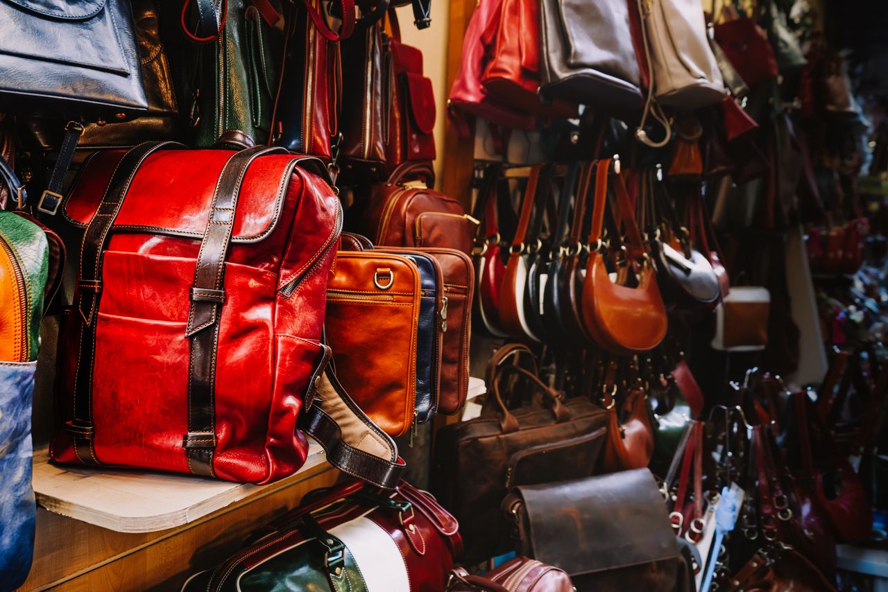 A rich assortment of handcrafted leather bags in a quaint artisan shop.